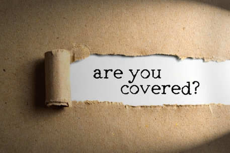 Paper bag ripped revealing "are you covered?" underneath