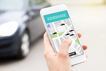 Person uses a rideshare app while standing on the street