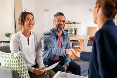 Couple sits on a couch consulting with a professional