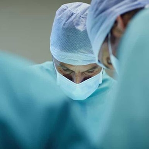 Doctors focus as they operate on a patient