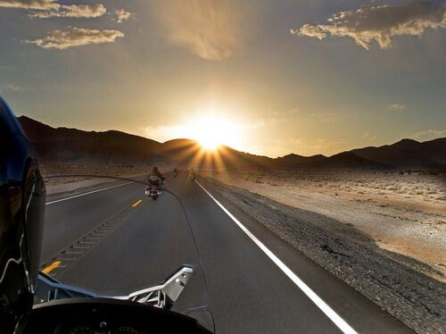 Motorcycle riding at sunset