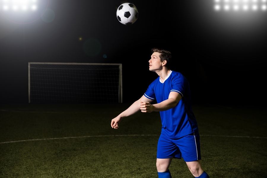 Soccer playing bouncing ball on head