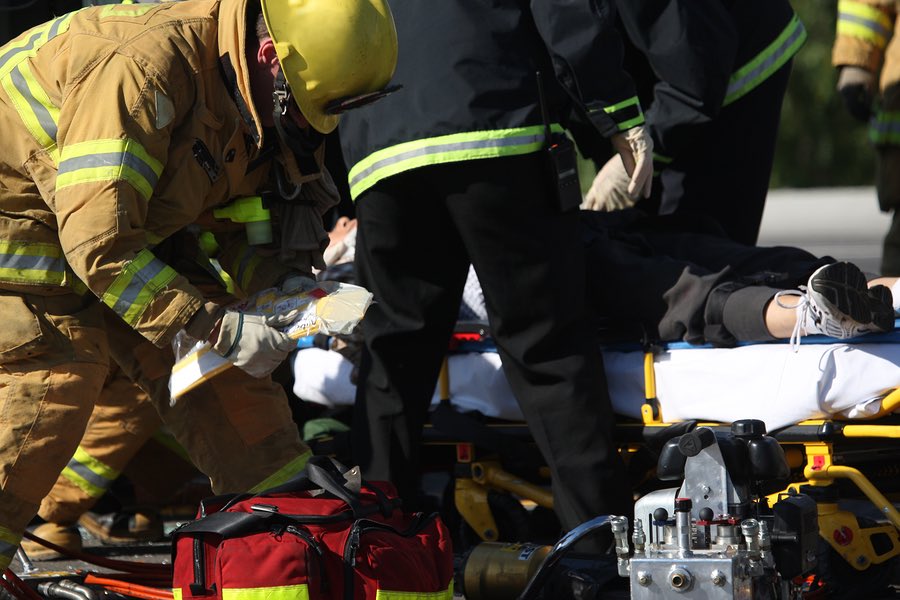 First responders treating patient at scene of accident